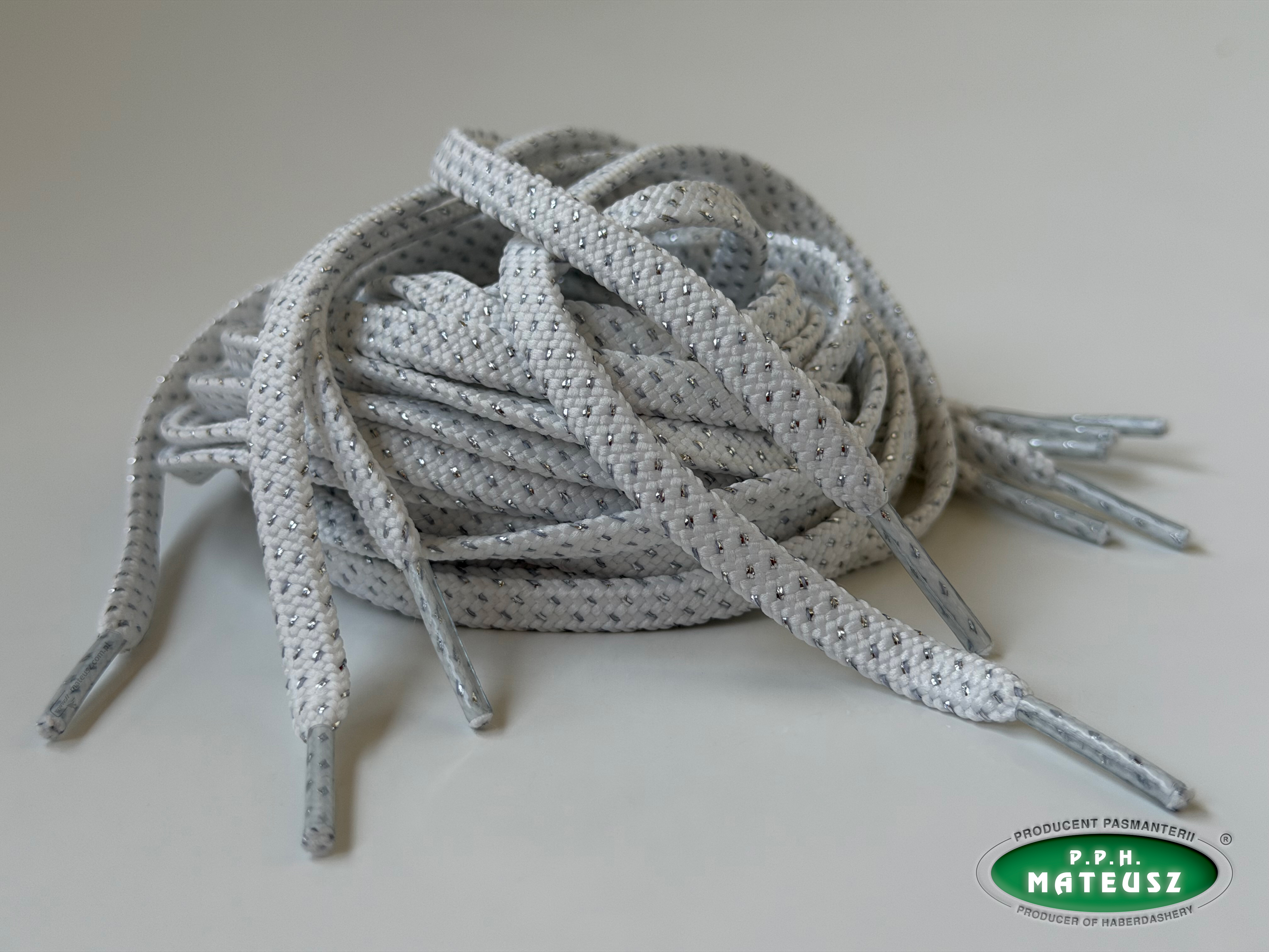 Białe płaskie sznurki poliestrowe ze srebrną nitką metalizującą - pierwsze ujęcie